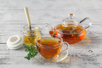 thyme tea with fresh bunches thyme, thyme inside teacup, white b