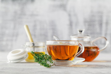 cup of thyme tea, fresh thyme on the old wooden background