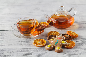 White tea cup with spices and xmas tree made of dried orange sli
