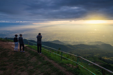 Fototapeta na wymiar Tourists photograph the sunrise on a mountains.