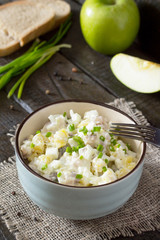 Salad with herring, eggs, apples and potatoes. Snack on a festiv