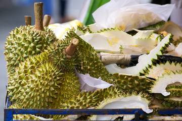 Peeled yellow Mon Thong durian on heap of durian fruits