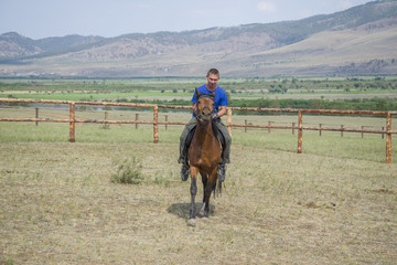 A young man touring the wild Mustang.