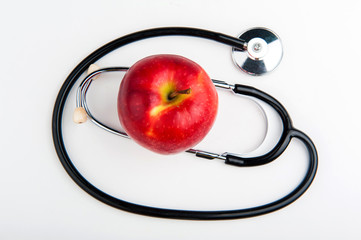 Stethoscope and Apple on white background