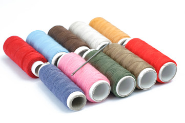 Multicolor sewing threads on white background. Colorful thread 