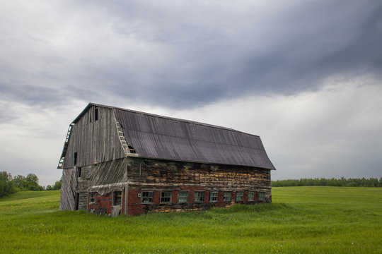 old barn in a large field