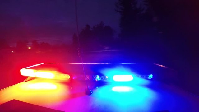 Point of View Police Car Top Flashing Lights Driving Through Neighborhood at Dawn/Dusk 1080P 24fps