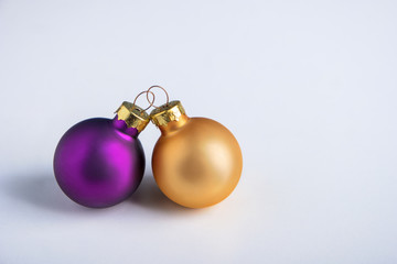 purple and gold christmas balls on a white background