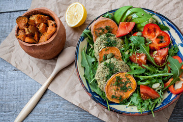 Arugula, vegan lentil fried cutlets, baked sweet potato, tomato, avocado, pepper.  Perfect for the detox diet or just a healthy meal.  Love for a healthy raw food concept.