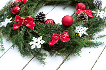 Fototapeta na wymiar Christmas wreath of tree branches on wooden background