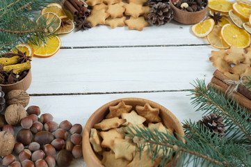 Christmas cookies stars on a white background with cinnamon chips orange cones twigs Christmas trees