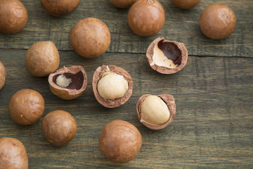 Macadamia nuts on wooden table (Macadamia integrifolia)