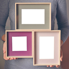 Woman holding blank wooden frames