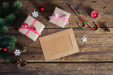 Christmas gift box with cards  on a wooden background with candy