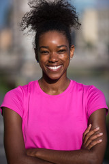 Fototapeta premium Portrait of sporty young african american woman running outdoors