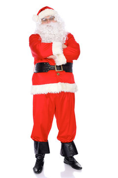 Santa Claus standing with ars crossed,  isolated on white background. Full length portrait
