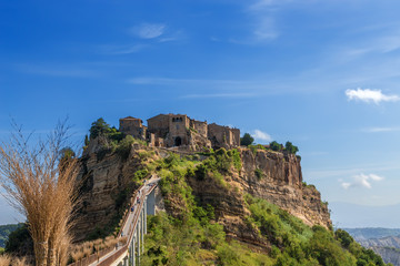 Fototapeta premium Civita di Bagnoregio, Italy. View from the bridge, decorated with brooms