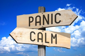 Panic, calm - wooden signpost