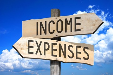 Income, expenses - wooden signpost