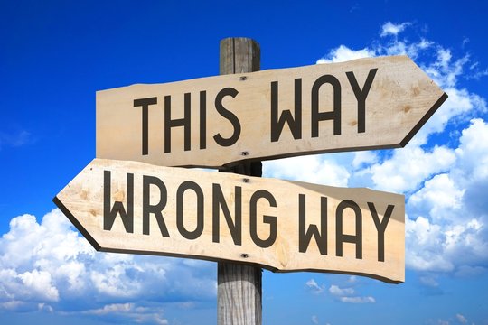 This way, wrong way - wooden signpost
