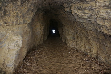 Inside a small tunnel in the rock connecting beaches of La Roche Percee to Turtle Bay, Bourail, Grande Terre, New Caledonia, south Pacific
