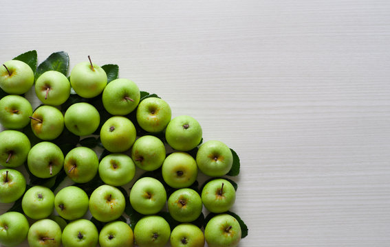 photo of fresh green apple on a white wooden