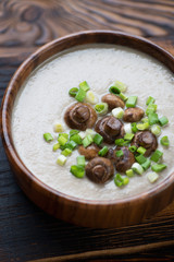 Champignon cream-soup topped with whole fried mushrooms, closeup