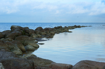 Stone ridge on the shore of the lake Huge boulders on the shore of the bay.