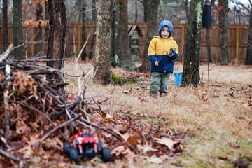 A child play with the radio control car outdoor