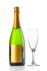 Champagne bottle and empty goblet on white background
