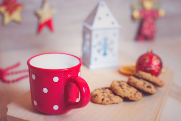 A mug of milk with cookies and christmas decorations