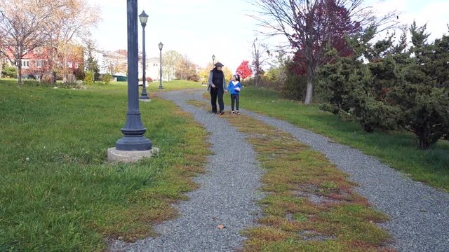 Woman and Girl walking in the park