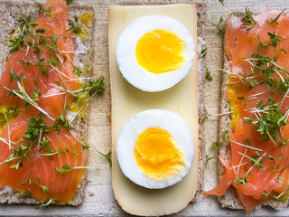 Set of three crisp-breads on wooden background. Healthy snack with eggs, salmon and cheese