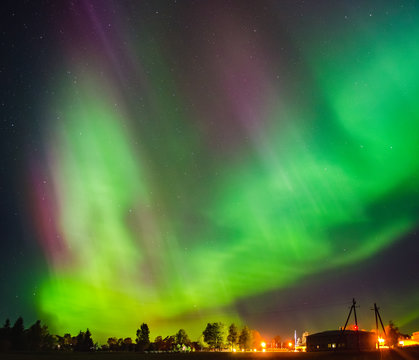 Northern lights (Aurora borealis) in the illuminated sky