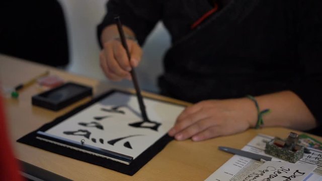 Japanese calligraphy master teaching the art of writing, hobby for meditation