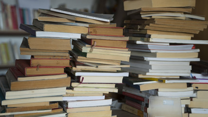 Books at wooden messy library at a school. 