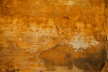 The rough surface of the rough stone yellow. Background in grunge style. texture of old wall with peeling paint. Abstract background yellow