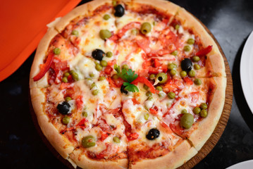Pizza with ham, pepper and olives