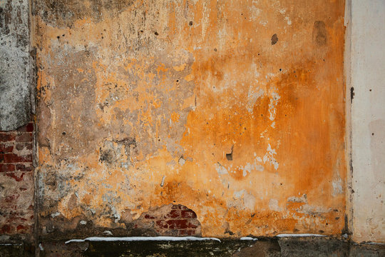 Natural design frame with brick and concrete wall. Background texture of old concrete surfaces, plaster falling off. Vintage grunge style