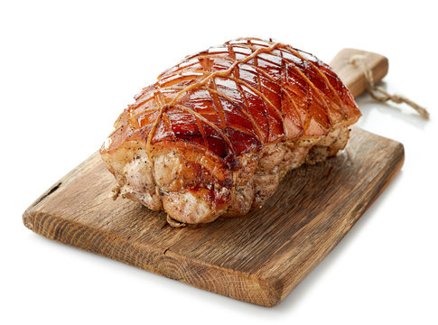 roasted pork on wooden cutting board