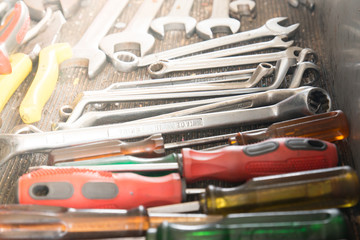 Fototapeta premium Work tools in a car garage vehicle repair. screwdriver for car fix on duty. Set of tolls in a case. Close up