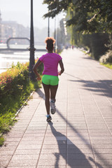 african american woman jogging in the city