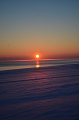 Sunset on a background of frozen sea