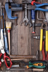 Set of old tools on wooden background, top view