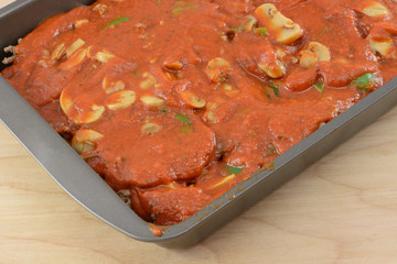 Close up of spaghetti casserole preparation in baking pan
