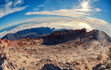 Fisheye lens aerial view. of volcano caldera from summit Pico del Teide mountain. Lava rocks and volcanic landscape in El Teide National park. Main landmark on Tenerife, Canary Islands, Spain.