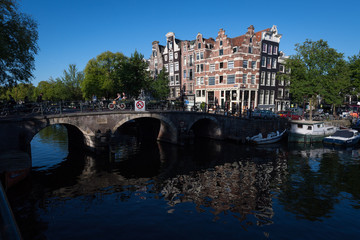 Crooked buildings in the early morning summer sun on the corner of the Browersgracht and Prinsengracht, Amsterdam, Netherlands