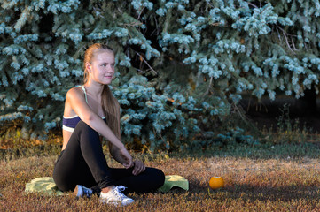 young girl resting sitting on the grass