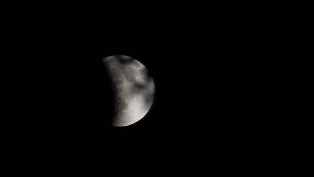 Time lapse - lunar eclipse partially covering moon moving