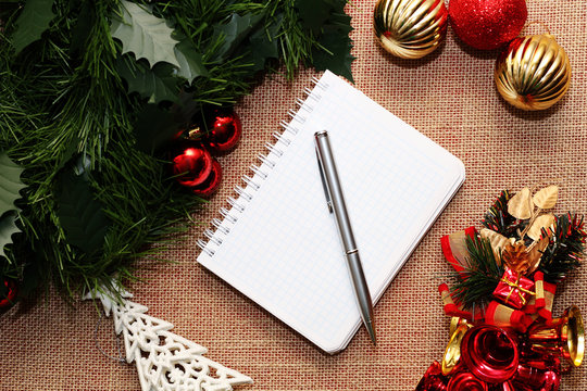 Notebook and pen in the beautiful Christmas decorations